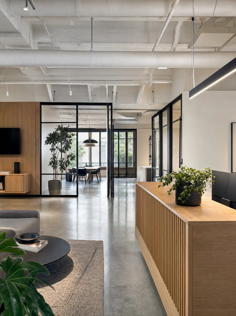 Commercial reception area with polished concrete and a custom millwork desk
